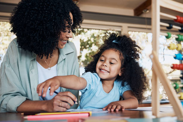 istock Happy, learning and a mother with a child for homework, education support and together for teaching. Smile, family and a young mom with a girl kid for writing, project or studying in a house 1754009466