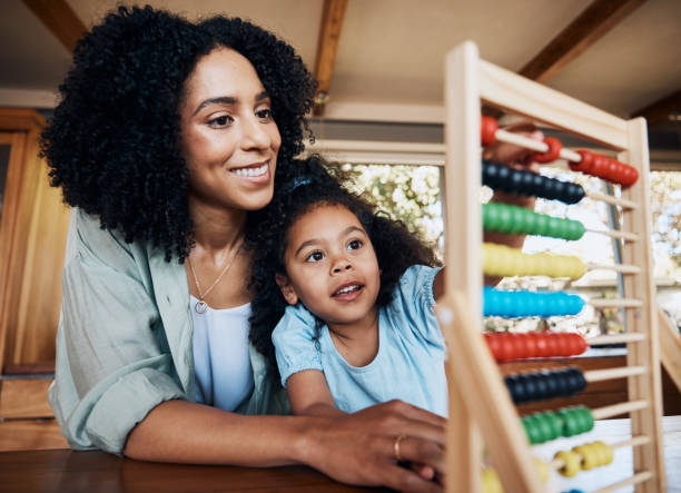 istock Abacus, mother and child learning, count and studying with math equipment for education, student development or project. Love, home school tutor and helping mama smile, support and teaching kid girl 1754009479