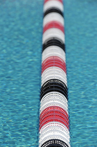 sport swimming pool sport swimming pool of 25 meters with lanes and blue water - ready for competition swimming pool lane ropes stock pictures, royalty-free photos & images