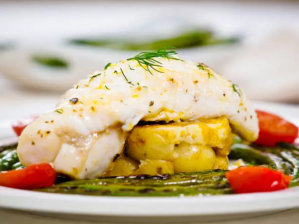 "Pan fried monkfish tail with grilled beans,cherry tomato and crashed garlic potato with garlic dill butter saucemore food photos,Click my food lightbox please."