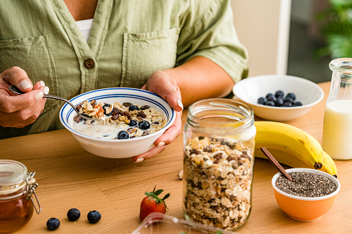 Woman eating healthy breakfast cereal