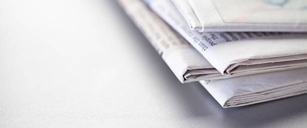 giornali quotidiani - close up newspaper folded document foto e immagini stock