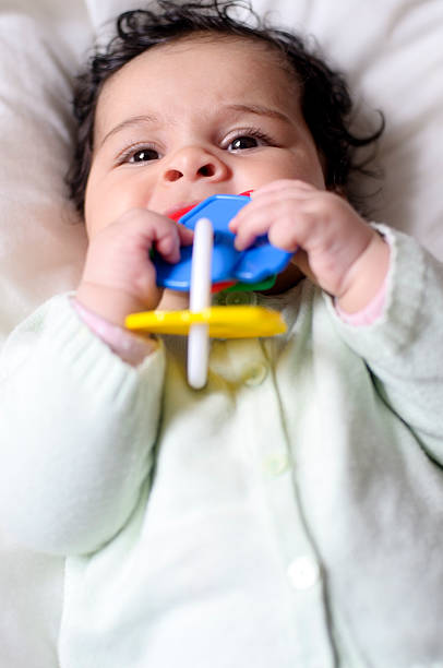 istock Baby (4 months old) Is Playing With Colorful Teething Ring 175401658
