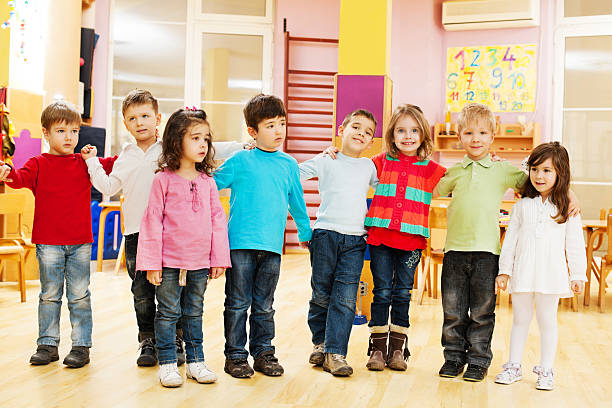 istock Group of embraced children standing in a line. 175401991
