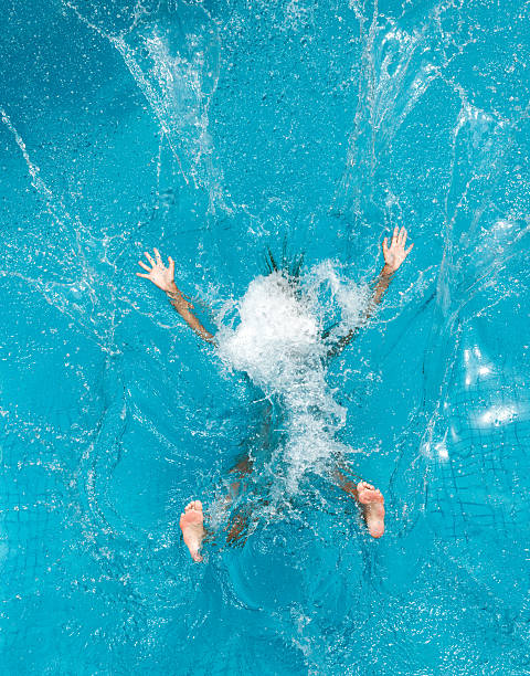Beautiful woman splashing backwards into a pool. Simply letting go. Nikon D3X. Converted from RAW. (XXXL)
