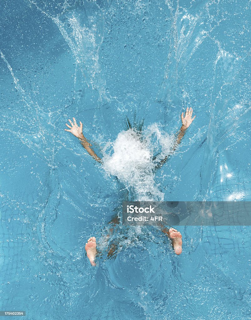 Person diving into pool and making a splash Beautiful woman splashing backwards into a pool. Simply letting go. Nikon D3X. Converted from RAW. (XXXL) Swimming Pool Stock Photo