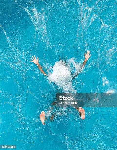 Person Diving Into Pool And Making A Splash Stock Photo - Download Image Now - Swimming Pool, Water, Jumping