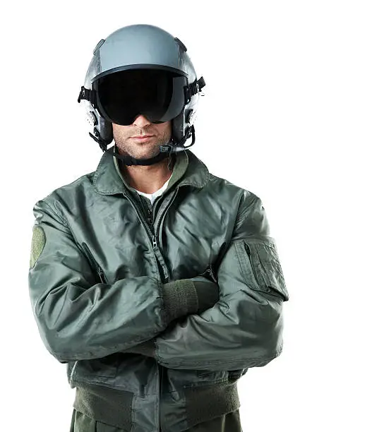 Confident male air-force pilot wearing a helmet and crossing his arms while isolated on white background - Copyspace