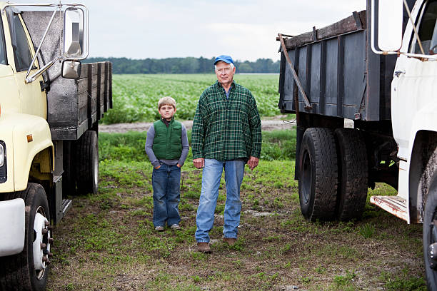 istock Farmer with grandson on potato farm 175402465