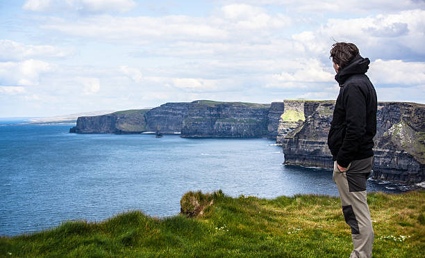 istock Man Looking the Cliffs of Moher in Ireland 175402523