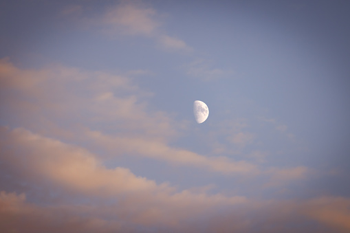 Beautiful clouds on blue sky at sunset with half moon.\nIstanbul - Turkey.