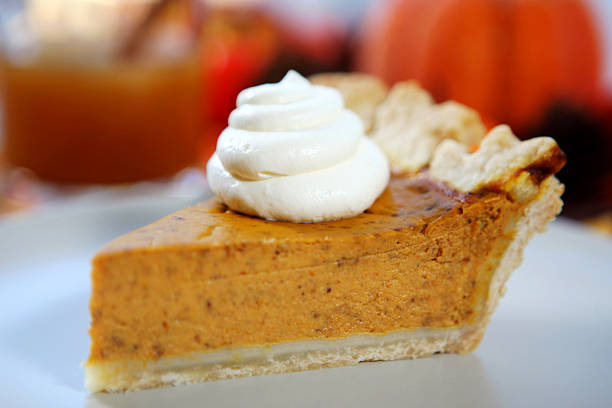 Slice of pumpkin pie with whipped cream