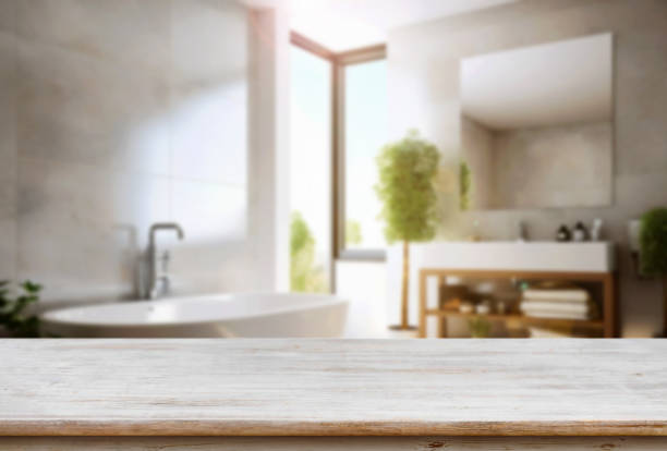istock Empty wooden table and blurred view of stylish bathroom interior. 1754026493