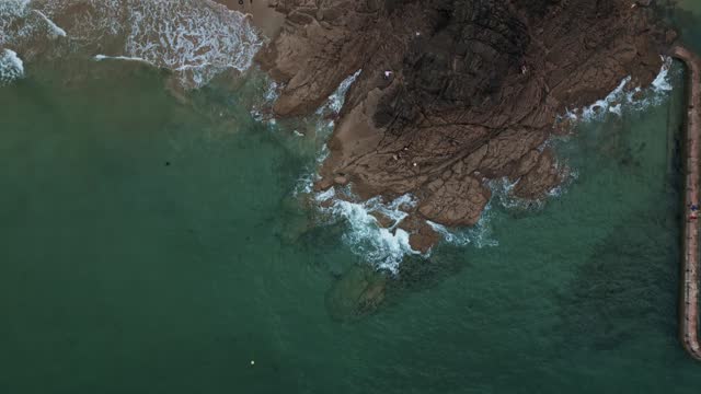 Aerial top-down forward over rocky coast of Saint-Malo in Brittany, France