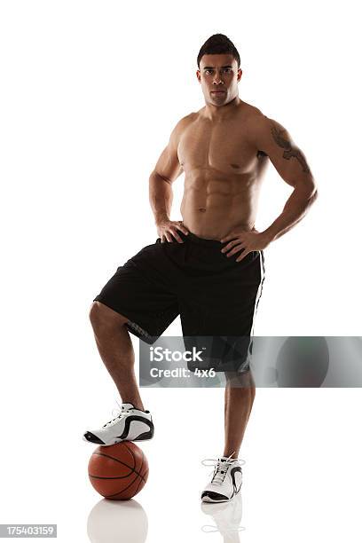 Athlete Standing With One Foot On A Basketball Stock Photo - Download Image Now - Shirtless, Cut Out, Men