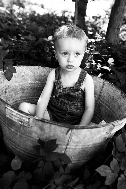 istock Little Boy Outside in Antique Bucket 175403172