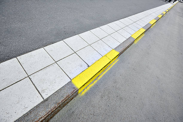 istock Sidewalk and yellow road markings 175403354