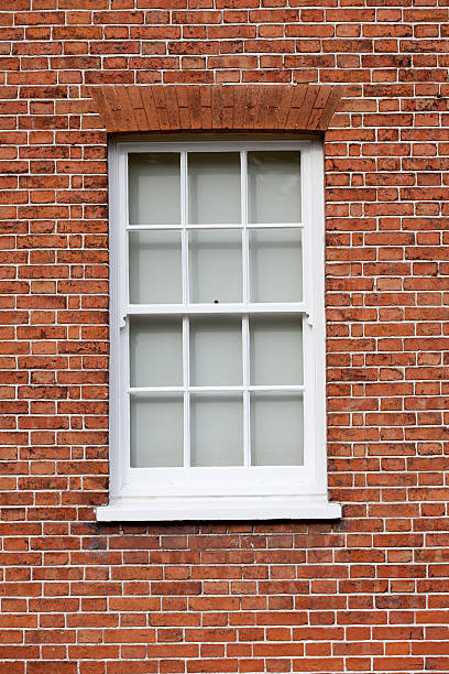 istock window in English brick house 175403470