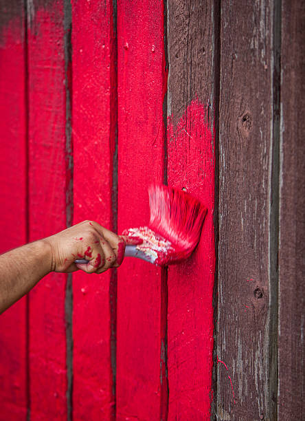 istock painting the fence red 175403589
