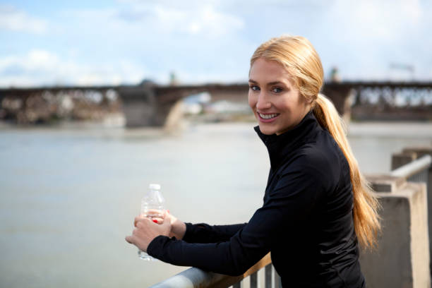 istock Athletic young woman smiles on waterfront 175403954