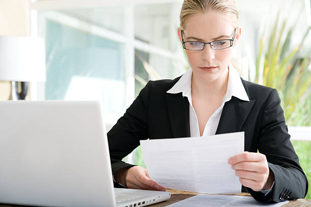 Business woman looking over papers stock photo