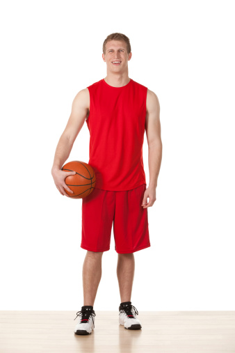 Happy sportsman holding a basketball