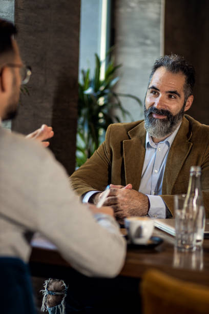 istock Two businessman having a business meeting in cafe. 1754043074