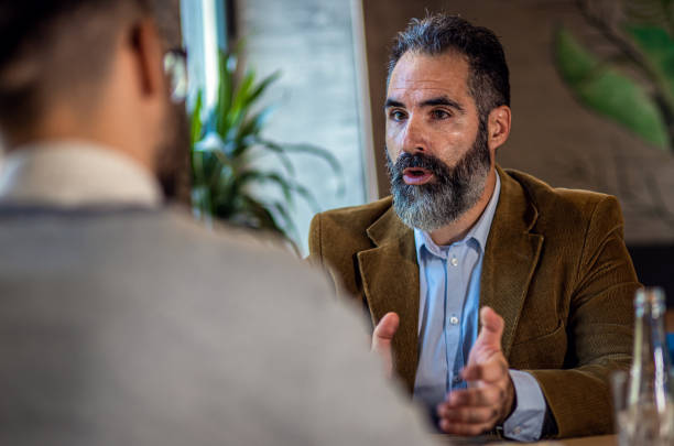 istock Two businessman having a business meeting in cafe. 1754043075