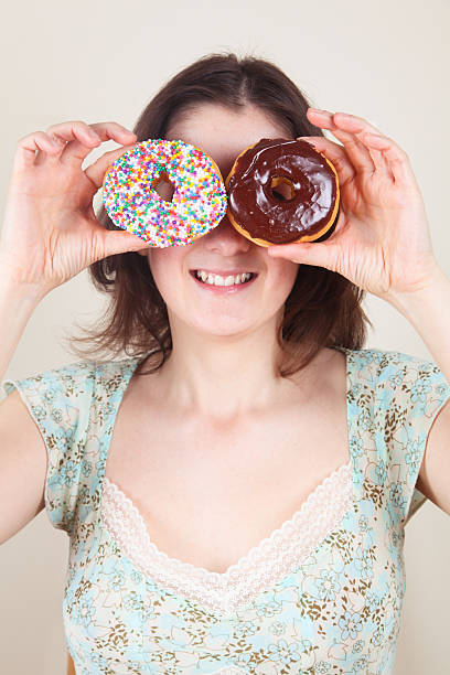 istock Beautiful woman playing with donut 175404324