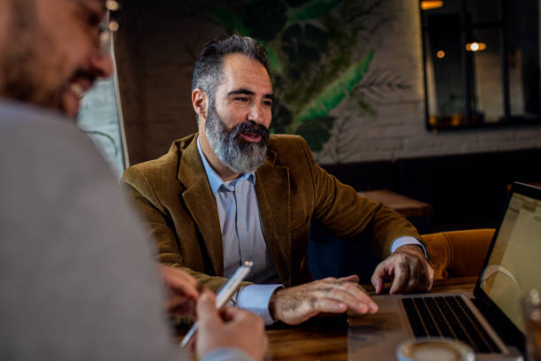 istock Two businessman having a business meeting in cafe. 1754043359