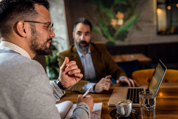 istock Two businessman having a business meeting in cafe. 1754043630