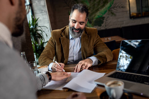 istock Two businessman having a business meeting in cafe. 1754043639