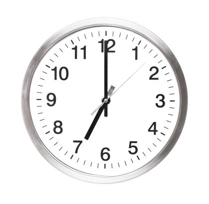 close-up of a white alarm clock isolated on a black background