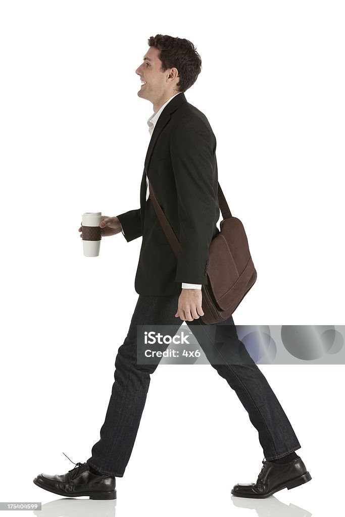 Businessman walking with a disposable cup Businessman walking with a disposable cuphttp://www.twodozendesign.info/i/1.png Walking Stock Photo