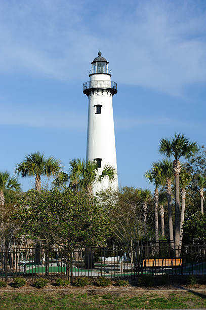 St. Simons Lighthouse "Shore-side view of the historic St. Simons Island Lighthouse, St. Simons Island, Georgia." saint simons island photos stock pictures, royalty-free photos & images