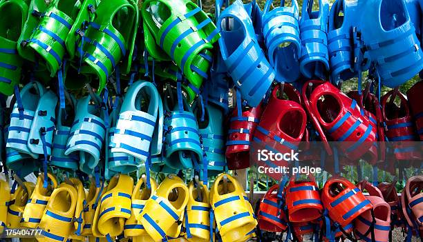 Colorful Life Jackets Hanging On Rack Stock Photo - Download Image Now - Aquatic Sport, Blue, Color Image