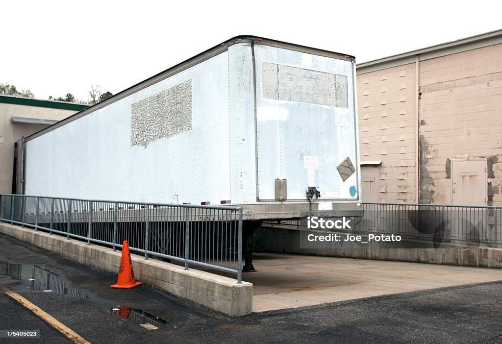 Semi Trailer Old, well-used parked semi trailer at warehouse loading dock. Horizontal. Car Transporter Stock Photo