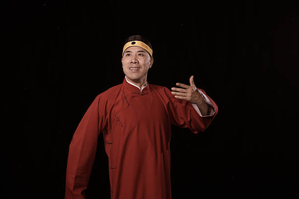 Martial artist with fighting pose in white Chinese KungFu dress.