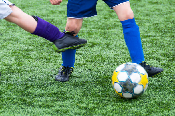 Soccer, kick on the knee Cause for free kick. This is during a game between seven year old boys foul stock pictures, royalty-free photos & images