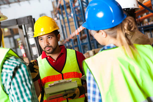 istock Diverse group of warehouse workers discussing shipping order with manager 175406142