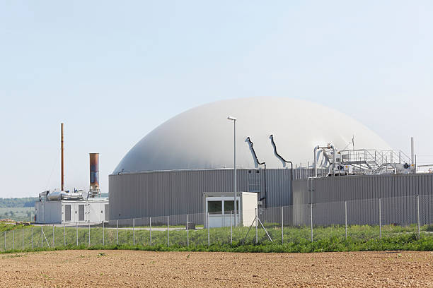 istock bio gas power plant generator behind fresh planted brown field 175406331
