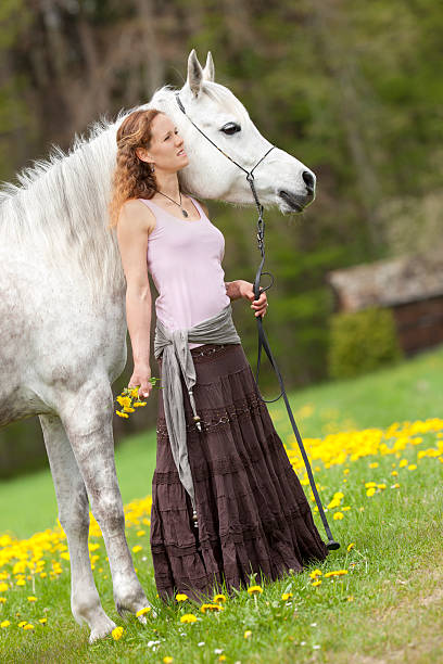 istock romantic woman with white horse 175406442