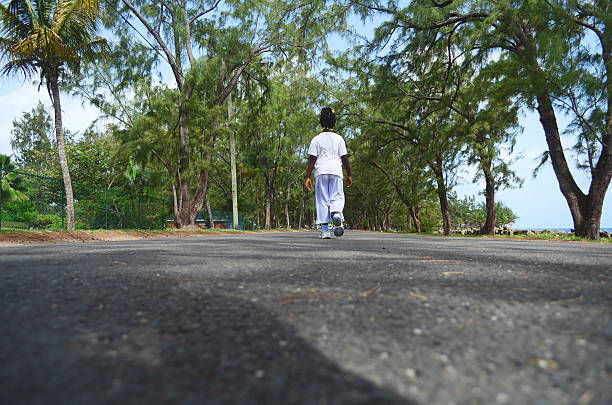child exercising walking on road among trees