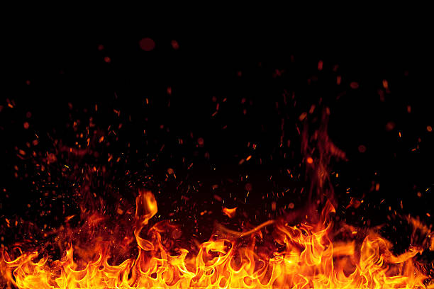 Photo of Fire with bright sparks isolated on black background