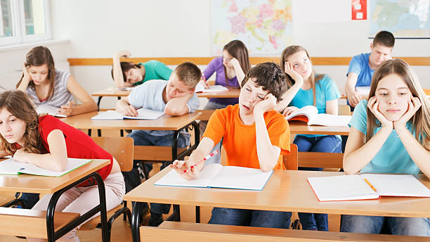 istock Schoolchildren bored in a classroom, during lesson. 175408082