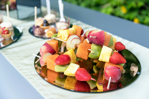 Mixed exotic fruits on skewers, party healthy snack. Party. Events.