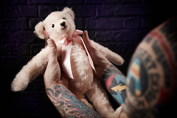 Tattooed man Tattooed man holding teddy bear man with teddy bear stock pictures, royalty-free photos & images