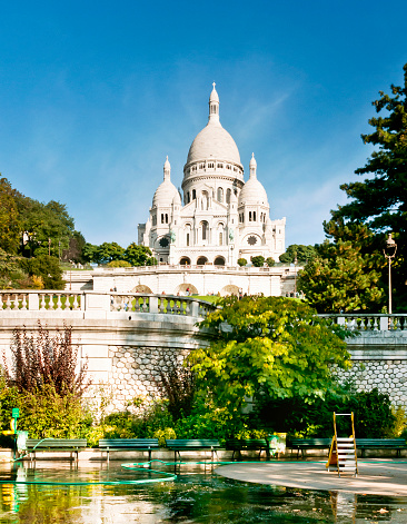 Sacre-Coeur de Montmartre in early morning light. Soft color effects with added grain.