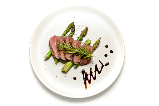 Filet of Lamb sliced on a bed of Asparagus with Balsamic Vinegar decoration