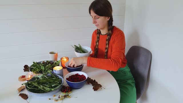 Woman Making Homemade Herbal Tea with Berries at Home